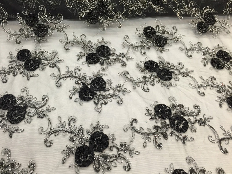 Black/silver  3d flowers embroider with sequins on a mesh lace fabric. Sold by the yard.