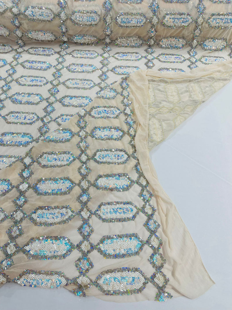 Aqua/Silver multi color iridescent Jewel sequin design on a Cream 4 way stretch mesh fabric.