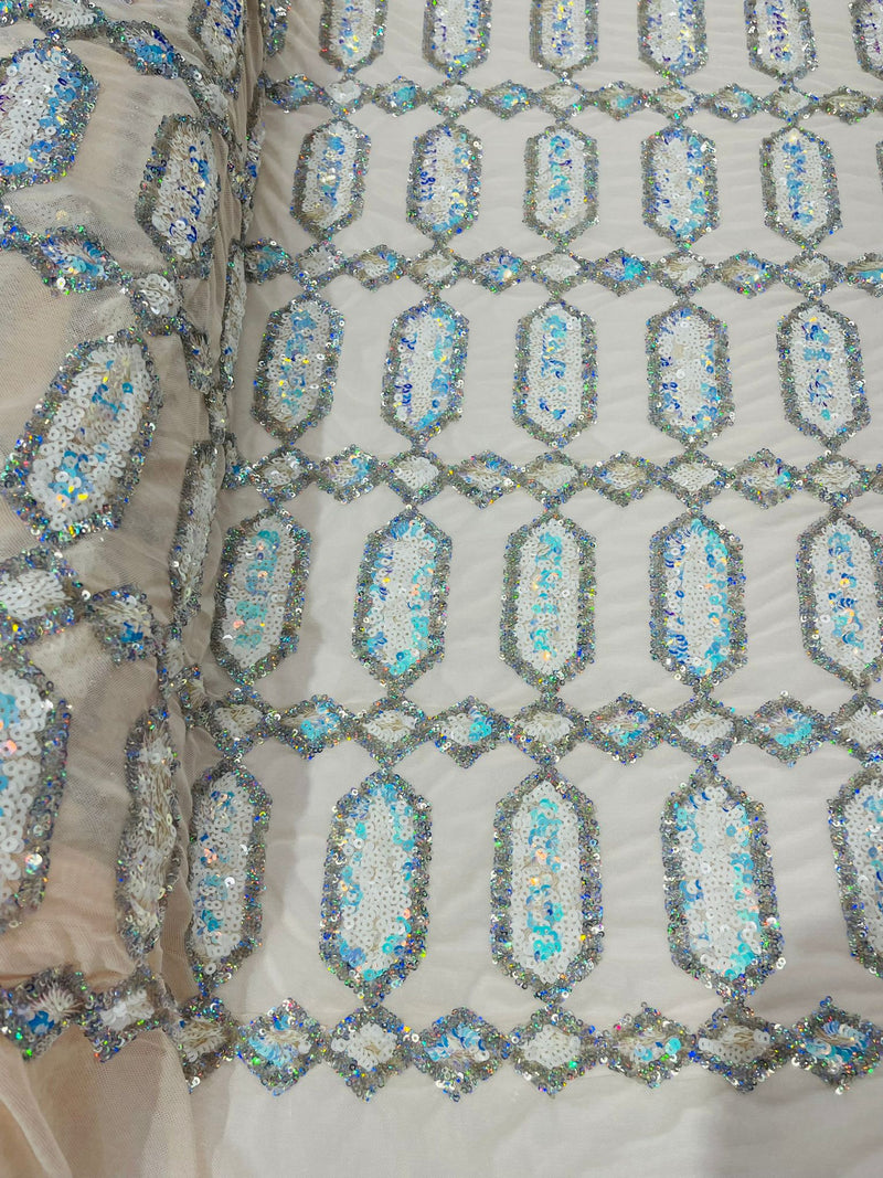 Aqua/Silver multi color iridescent Jewel sequin design on a Cream 4 way stretch mesh fabric.