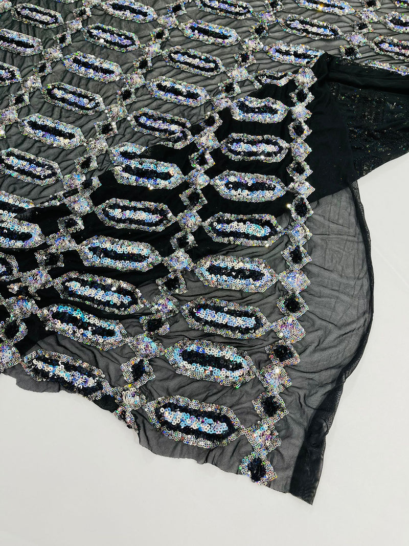 Aqua/Silver multi color iridescent Jewel sequin design on a black 4 way stretch mesh fabric.
