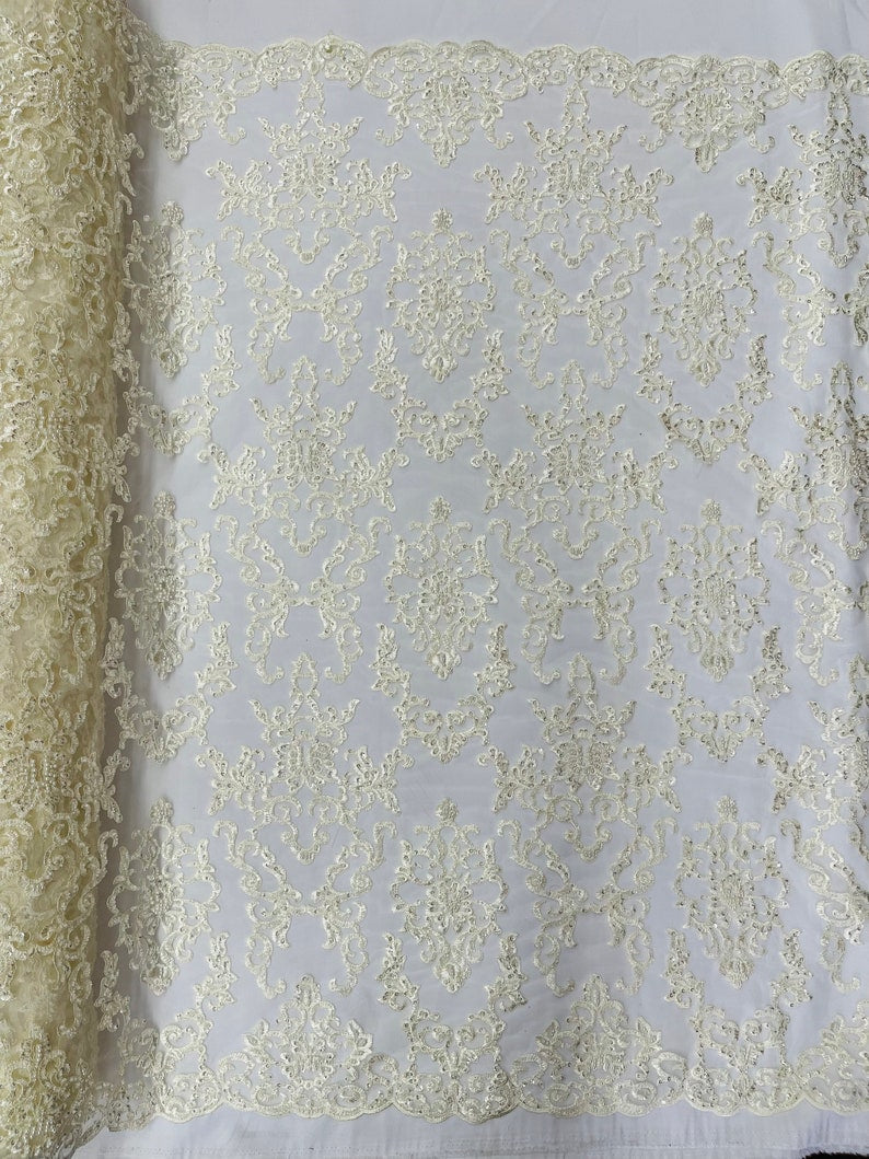 Ivory Damask embroider with sequins and heavy beaded on a mesh lace fabric-sold by the yard
