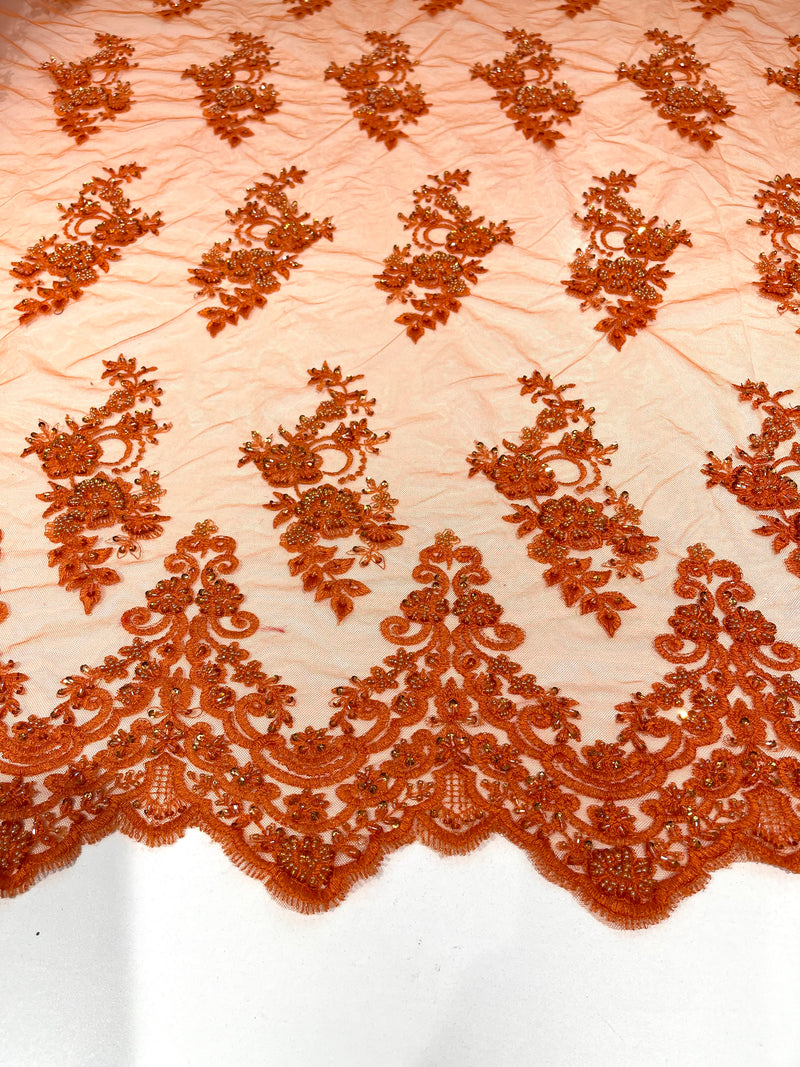 Orange elegant hand beaded flower design embroider on a mesh lace-prom-sold by the yard.