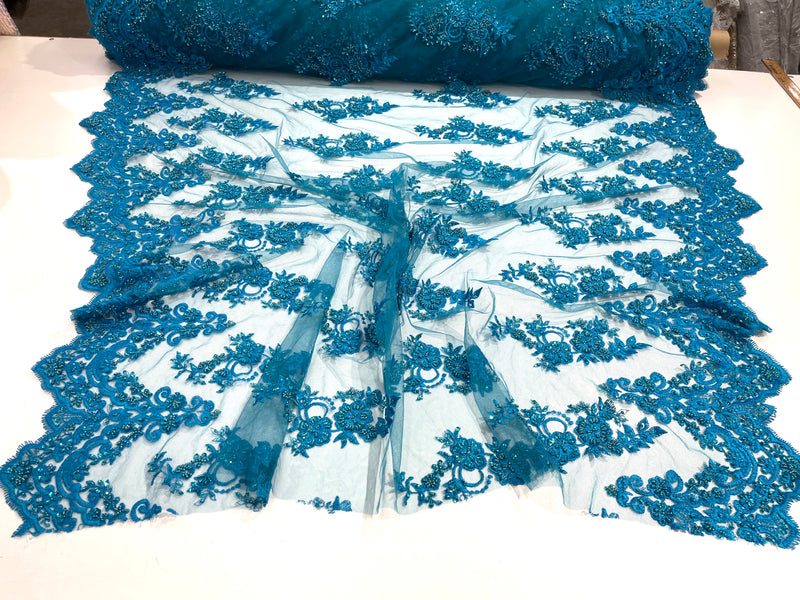 Turquoise elegant hand beaded flower design embroider on a mesh lace-prom-sold by the yard.