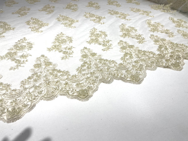 Ivory elegant hand beaded flower design embroider on a mesh lace-prom-sold by the yard.