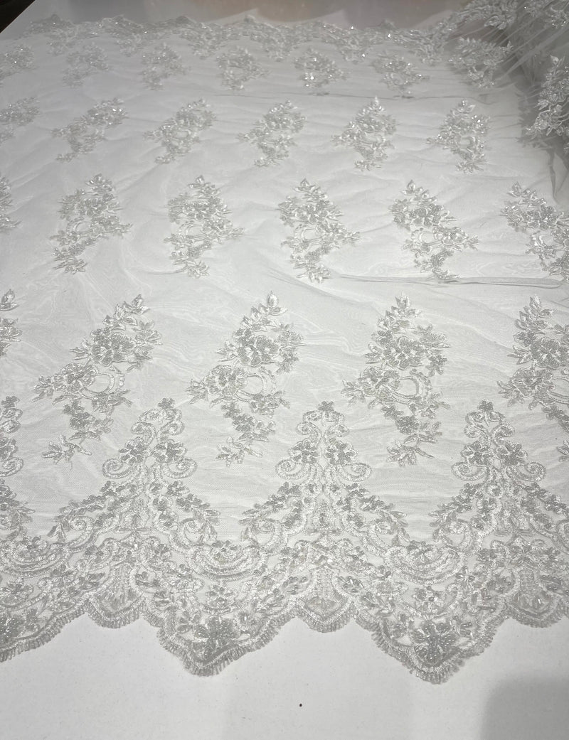 White elegant hand beaded flower design embroider on a mesh lace-prom-sold by the yard.