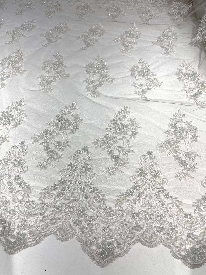 White elegant hand beaded flower design embroider on a mesh lace-prom-sold by the yard.