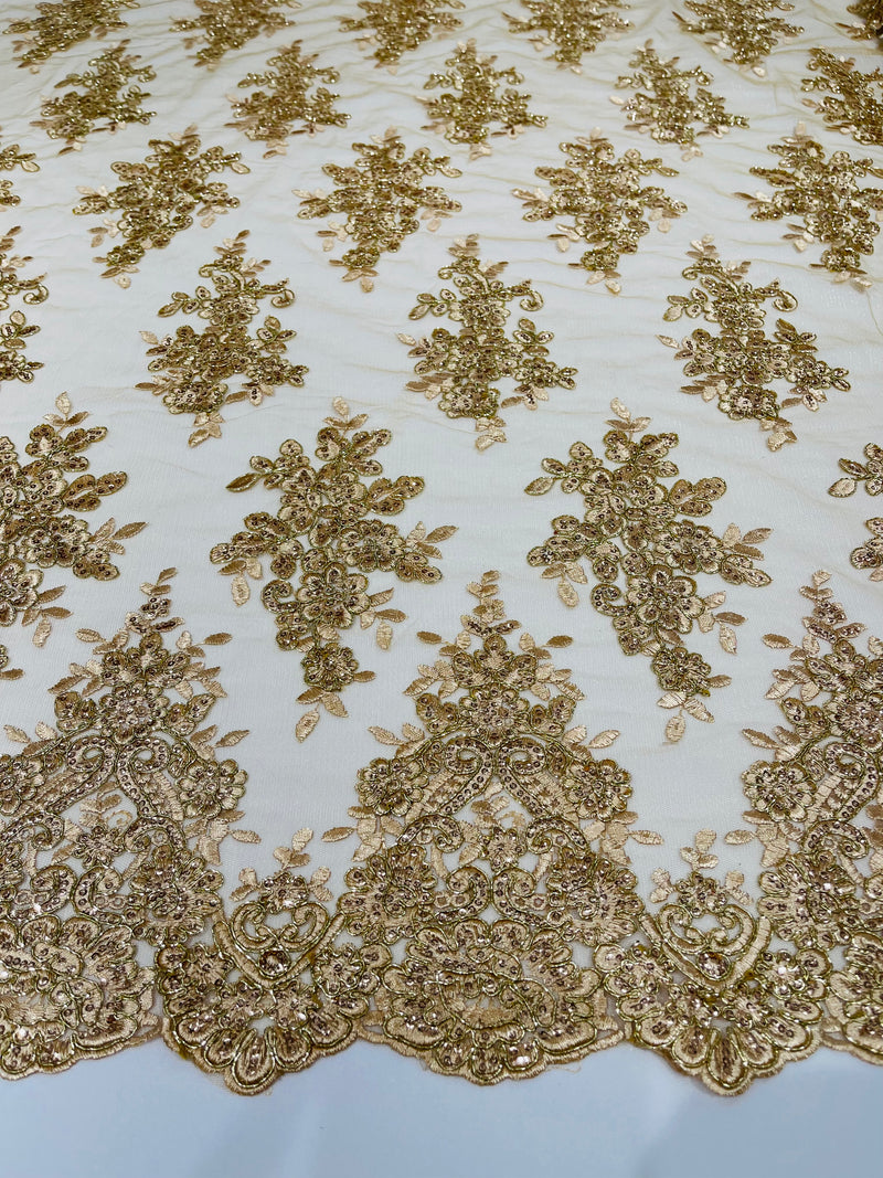 Champagne metallic floral design embroidery on a mesh lace with sequins and cord-sold by the yard.