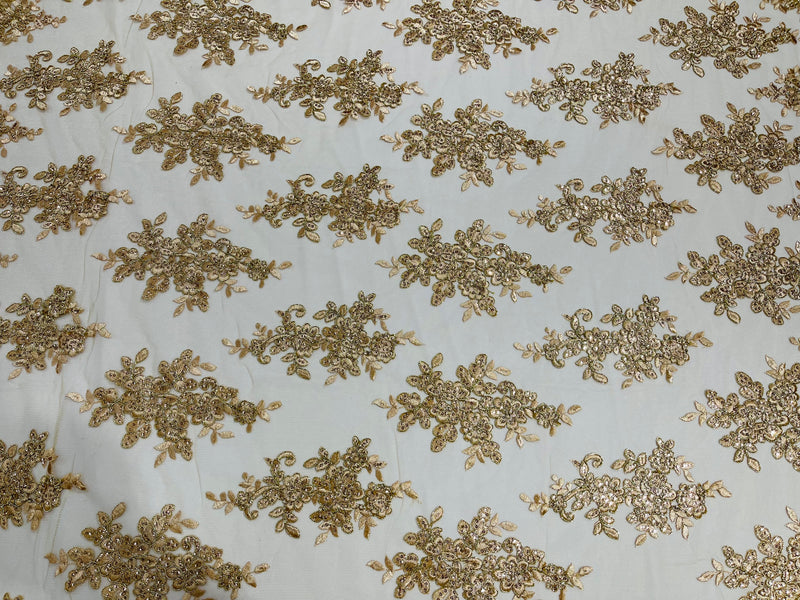 Champagne metallic floral design embroidery on a mesh lace with sequins and cord-sold by the yard.