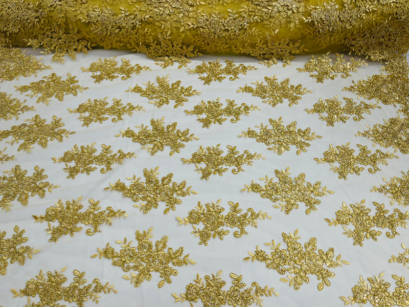 Gold Metallic floral design embroidery on a mesh lace with sequins and cord-sold by the yard.