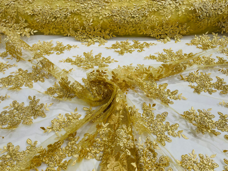 Gold Metallic floral design embroidery on a mesh lace with sequins and cord-sold by the yard.