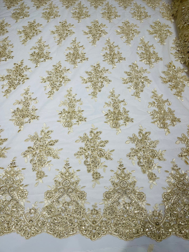 Beige floral design embroidery on a mesh lace with sequins and cord-sold by the yard.