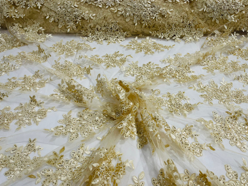 Beige floral design embroidery on a mesh lace with sequins and cord-sold by the yard.