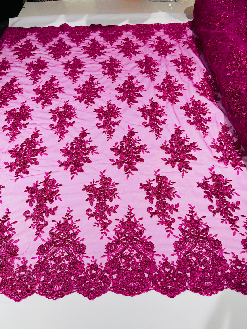 Fuchsia floral design embroidery on a mesh lace with sequins and cord-sold by the yard.