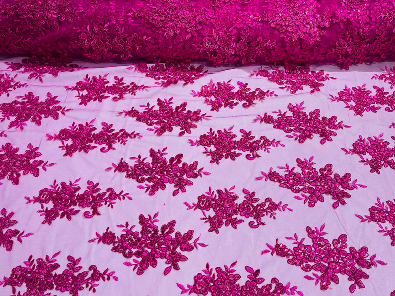 Fuchsia floral design embroidery on a mesh lace with sequins and cord-sold by the yard.