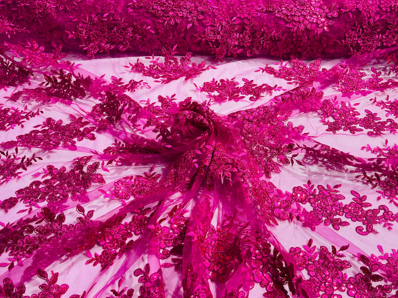Fuchsia floral design embroidery on a mesh lace with sequins and cord-sold by the yard.