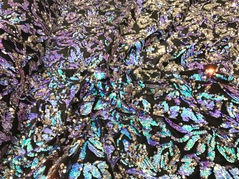 Aqua iridescent, silver sequins flip two tone floral design on a black stretch velvet, Sold by the yard.