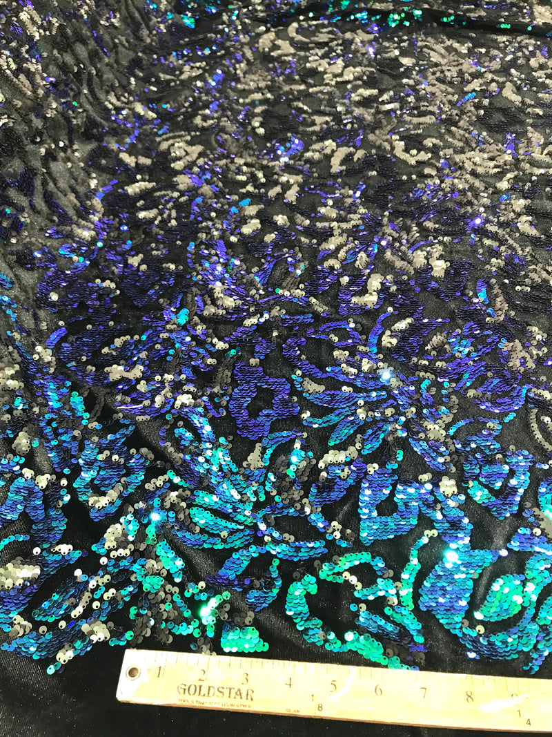 Green iridescent, matte black sequins flip two tone floral design on a black stretch velvet, Sold by the yard.