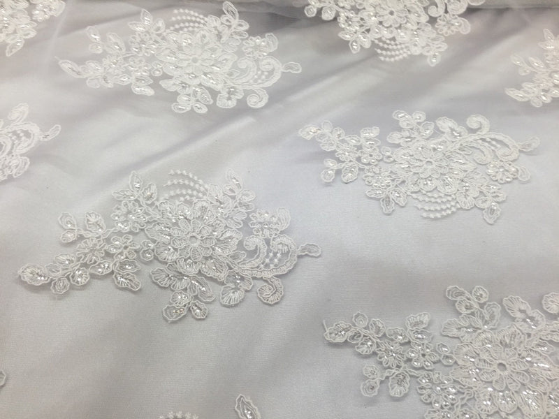 White flower lace corded and embroider with sequins on a mesh. Wedding/bridal/prom/nightgown fabric. Sold by the yard.