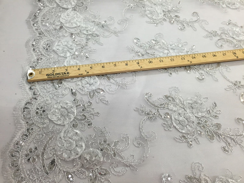 White  3d flowers embroider with sequins on a mesh lace fabric. Sold by the yard.