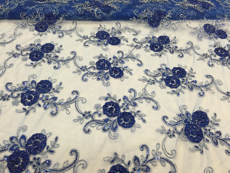 Royal blue 3d flowers embroider with sequins on a mesh lace fabric. Sold by the yard.