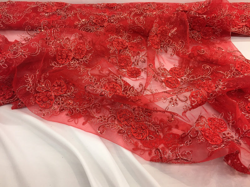 Red/silver  3d flowers embroider with sequins on a mesh lace fabric. Sold by the yard.