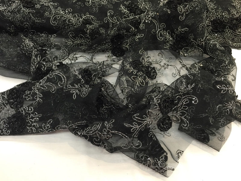 Black/silver 3d flowers embroider with sequins on a black mesh lace. Wedding/bridal/prom/nightgown fabric. Sold by the yard.