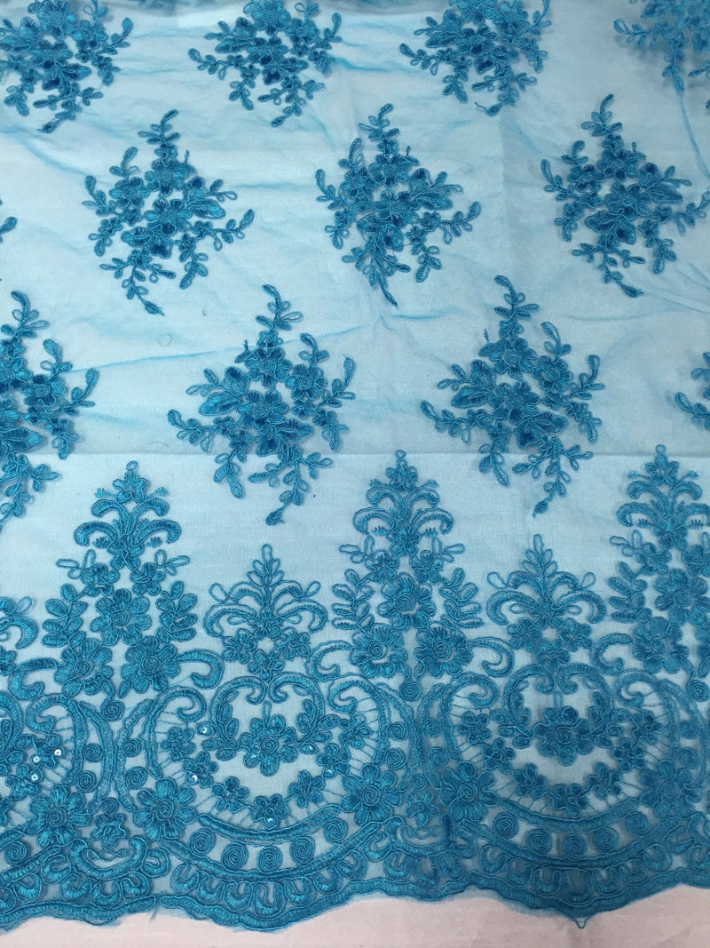 Turquoise royal flower design embroider with sequins and corded on a mesh lace -yard