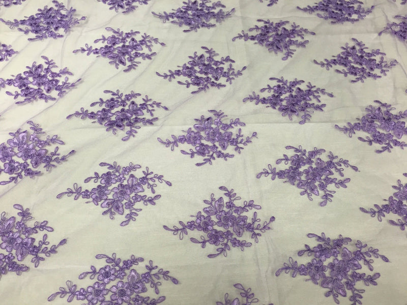 Lavender royal flowers embroider with sequins and corded on a mesh lace -yard