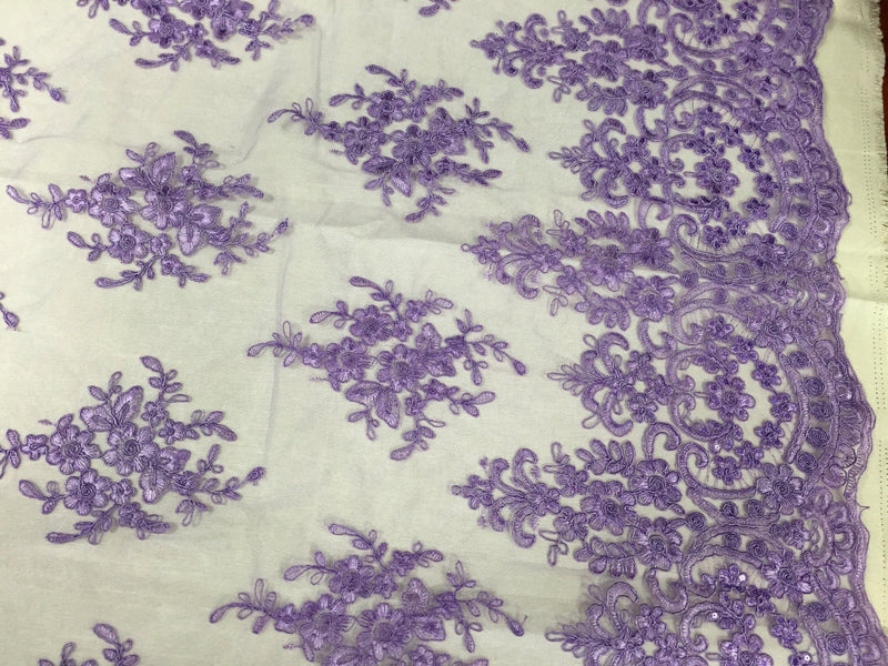 Lavender royal flowers embroider with sequins and corded on a mesh lace -yard