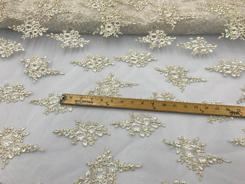 Ivory paisly flower enbroider and corded with metallic gold tread on a mesh lace-wedding-bridal-prom-nightgown-dresses-sold by the yard.