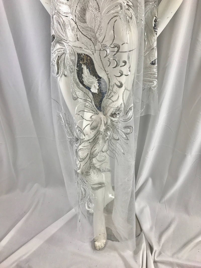 White peacock feathers embroider with shiny silver sequins on a white mesh-apparel-fashion-decorations-dresses-nightgown-sold by 2 panels.