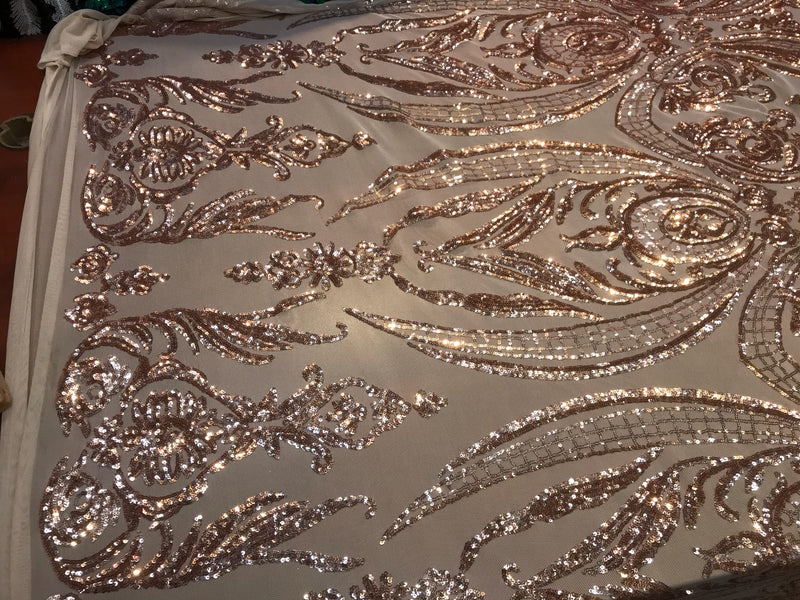 Rose gold empire design embroidered with shiny sequins on a 4 way Stretch Mesh-sold by the yard.