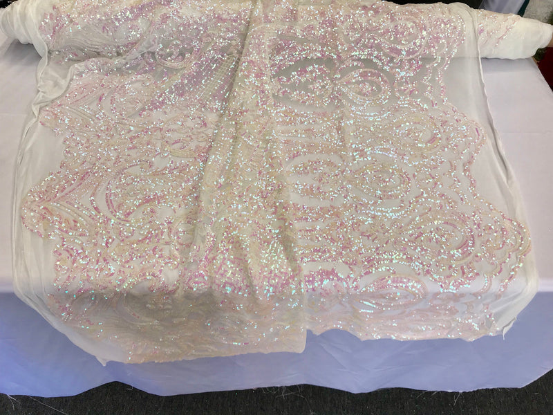 Pink princess design iridescent sequins on a 4 way stretch white mesh-sold by the yard.