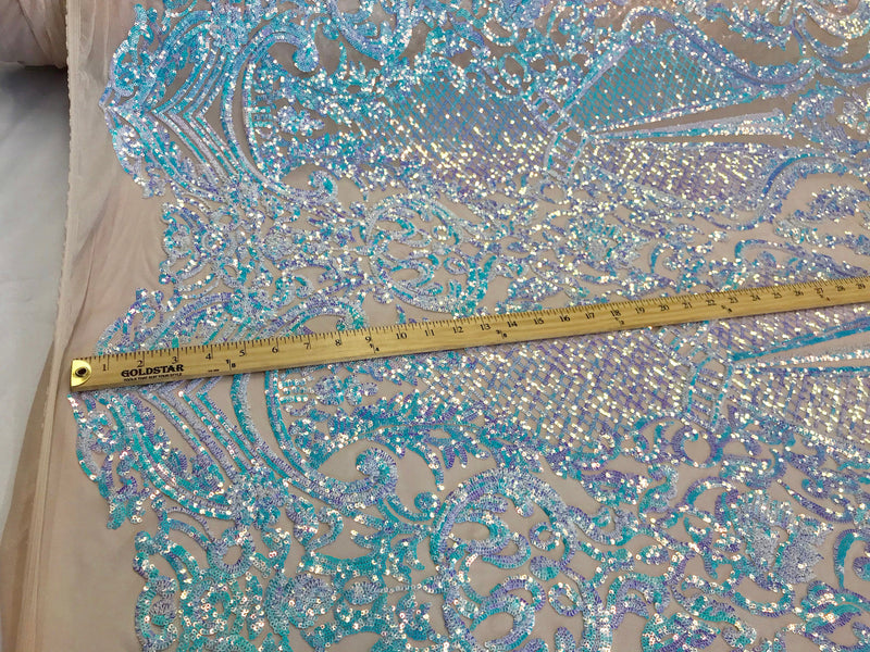 Aqua princess design iridescent sequins embroidery on a 4 way stretch nude mesh-sold by the yard.