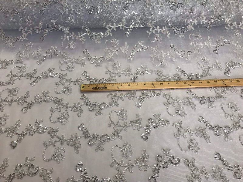 White metallic floral embroidery with shiny sequins and cord on a mesh lace-dresses-fashion-apparel-prom-nightgown-sold by the yard.