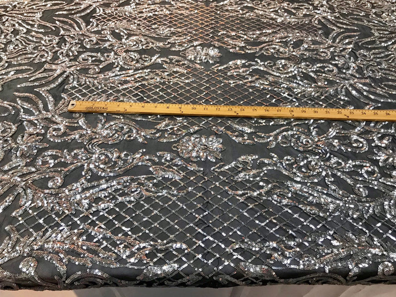 Silver shiny sequin damask design embroidery on a 4 way stretch black mesh-sold by yard.