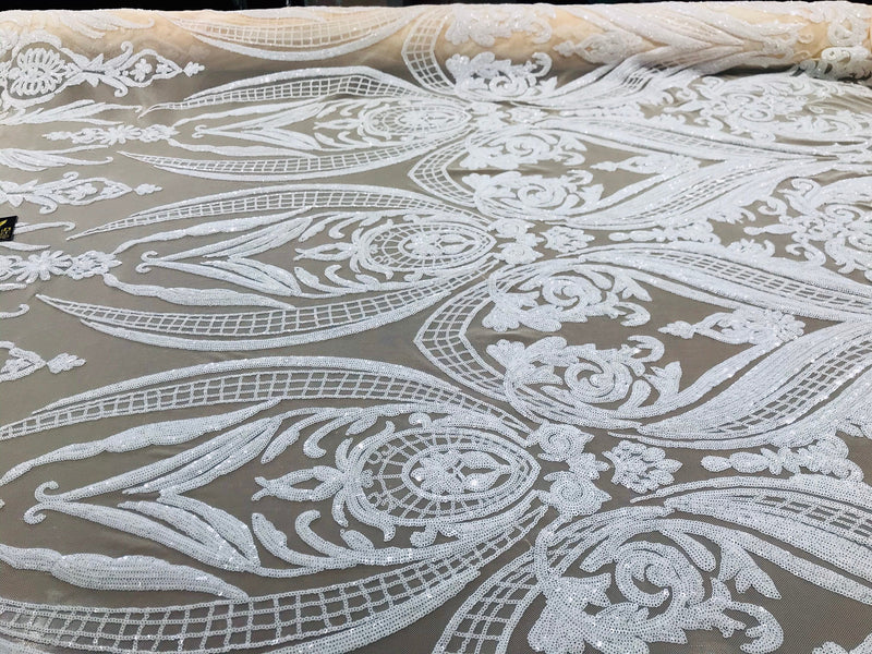 White big damask sequin design on a ivory 4 way stretch mesh-sold by the yard.