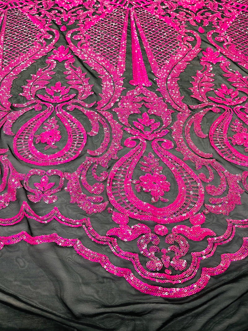 Hot pink princess design iridescent sequins on a 4 way stretch black mesh-sold by the yard.