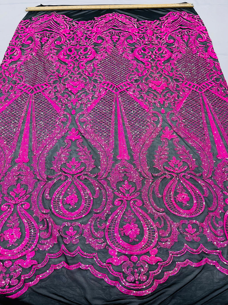 Hot pink princess design iridescent sequins on a 4 way stretch black mesh-sold by the yard.
