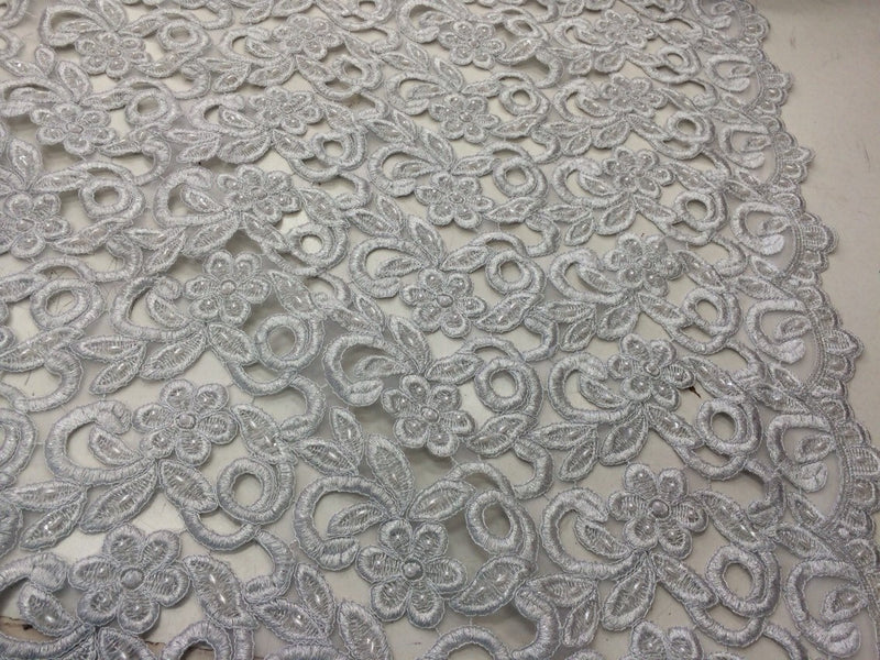 Silver metallic flowers embroider and hand beaded organza lace.36x50inches. Sold by the yard.