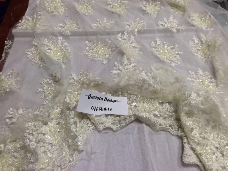 Ivory gaviota design embroider and beaded on a mesh lace. Wedding/Bridal/Prom/Nightgown fabric. Sold by the yard.