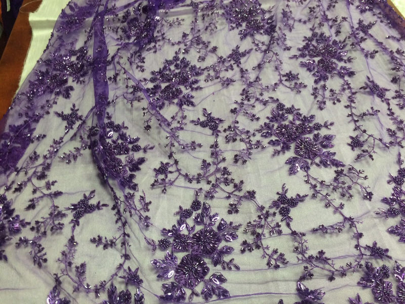 Gorgeous purple flower design embroider and beaded on a mesh lace. Wedding/Bridal/Prom/Nightgown fabric. Sold by the yard.
