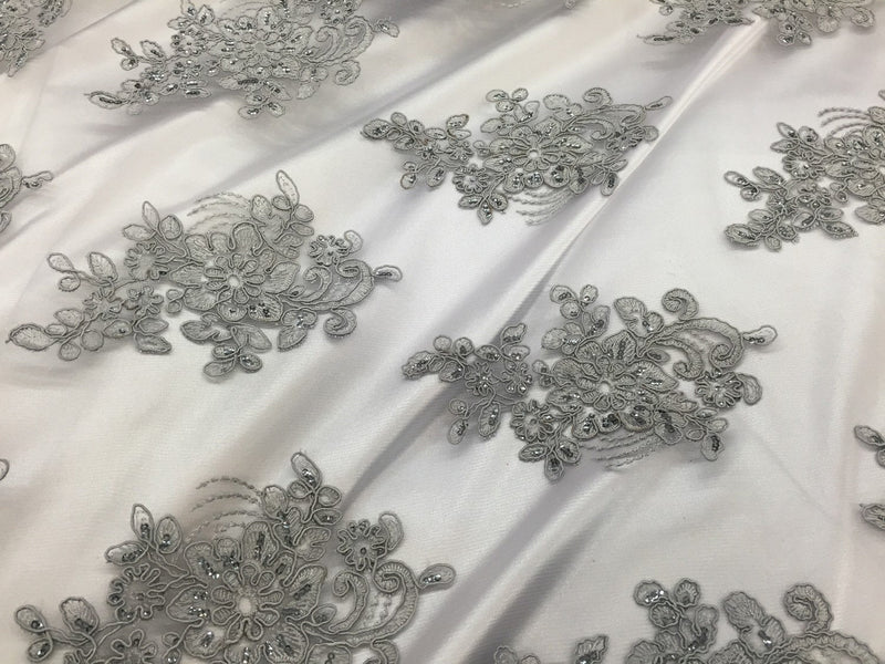 Gray flower lace corded and embroider with sequins on a mesh. Wedding/bridal/prom/nightgown fabric. Sold by the yard.