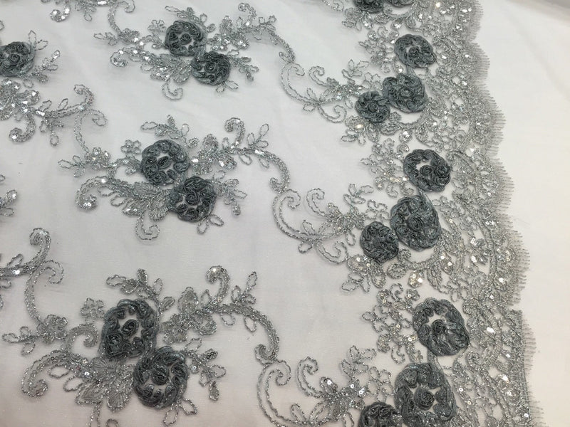 Gray/silver 3d flowers embroider with sequins on a silver mesh lace. Wedding/bridal/prom/nightgown fabric. Sold by the yard.
