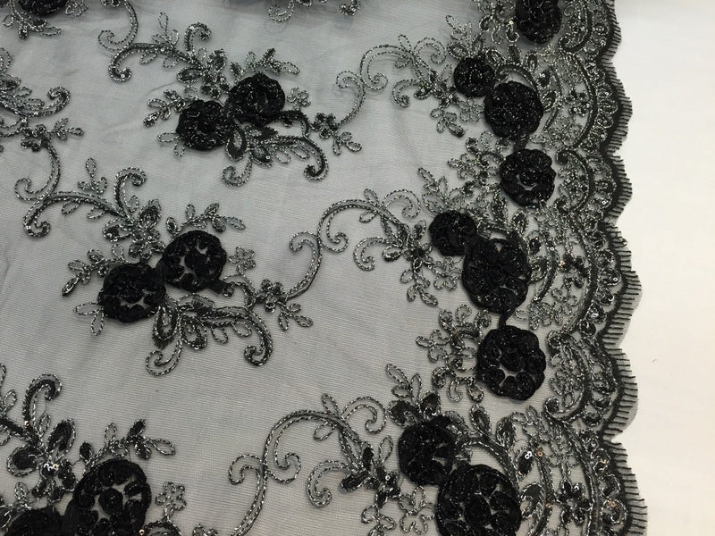 Black/silver 3d flowers embroider with sequins on a black mesh lace. Wedding/bridal/prom/nightgown fabric. Sold by the yard.