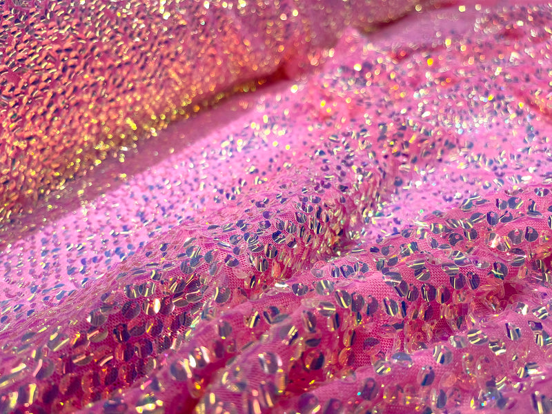 Aqua Clear iridescent mini round paillette sequins on a candy pink stretch mesh, sold by the yard.