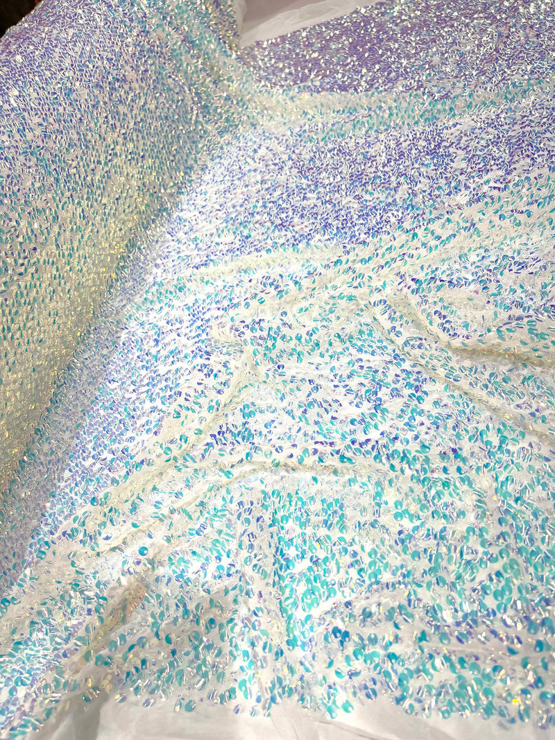 Aqua Clear iridescent mini round paillette sequins on a white stretch mesh, sold by the yard.