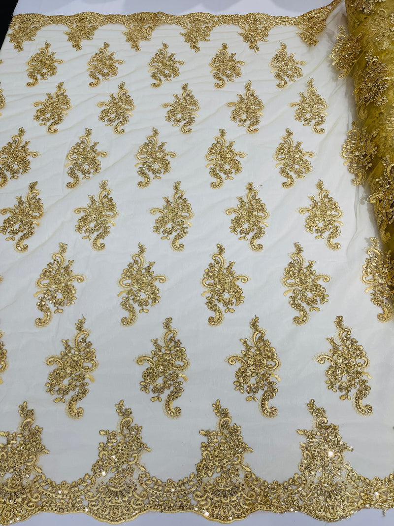 Gold metallic floral design embroidery on a mesh lace with sequins and cord-sold by the yard.