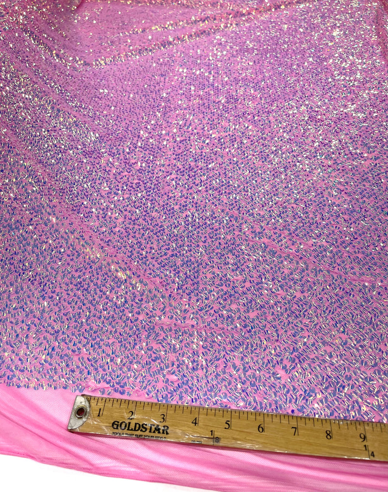 Aqua Clear iridescent mini round paillette sequins on a candy pink stretch mesh, sold by the yard.
