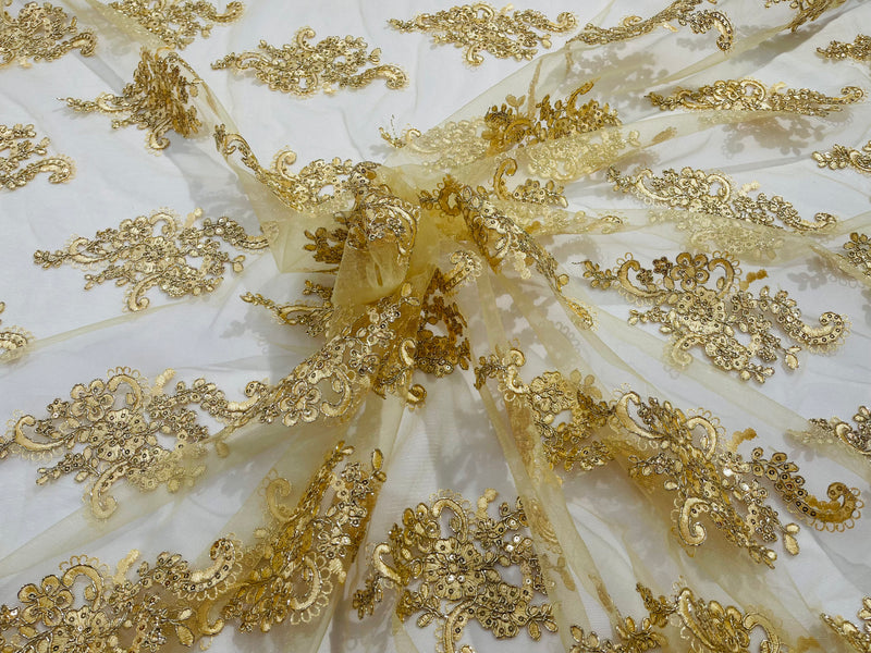 Gold metallic floral design embroidery on a mesh lace with sequins and cord-sold by the yard.